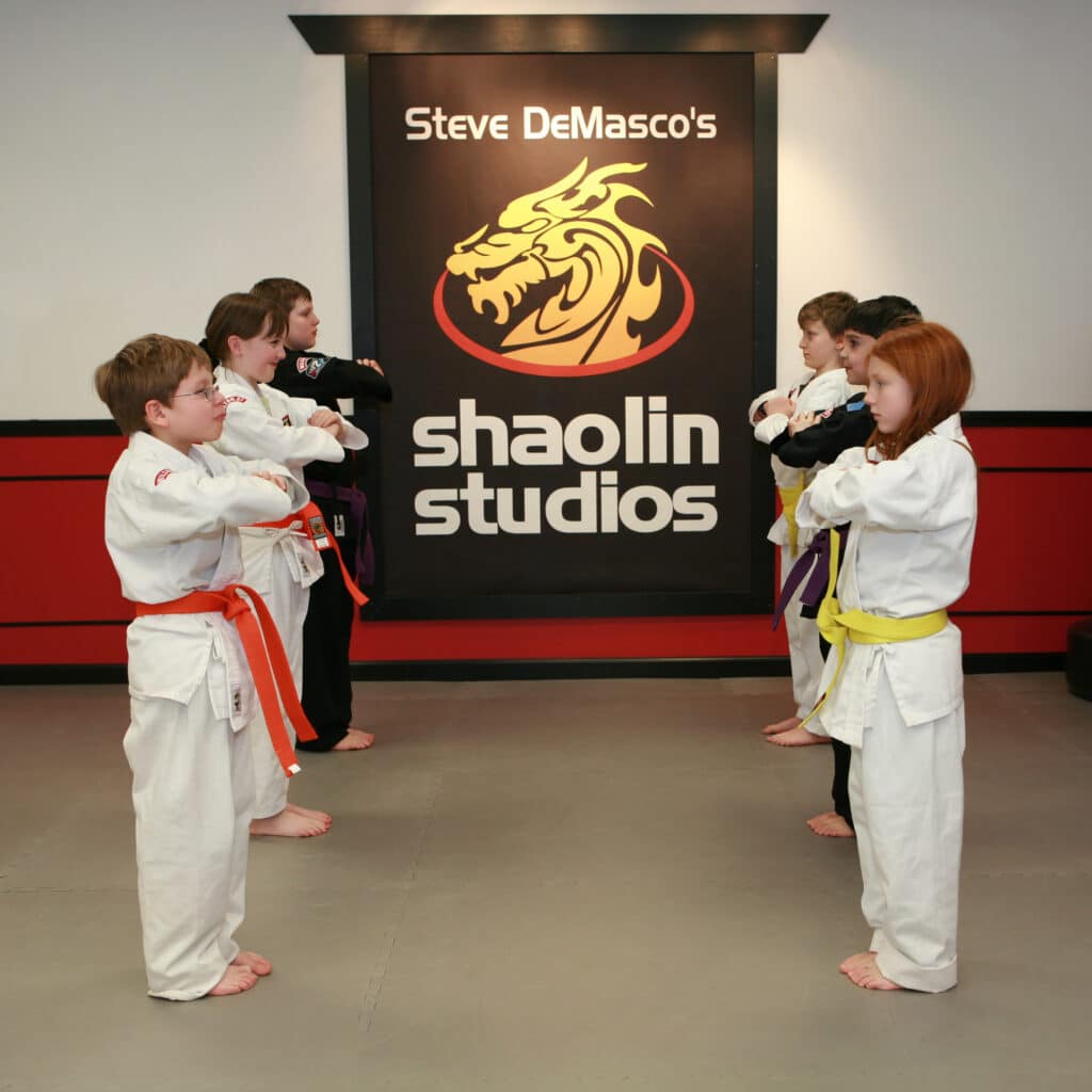 Teaching discipline to kids in martial arts class.