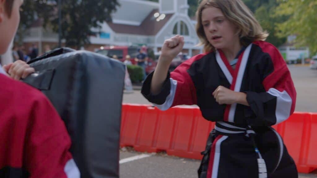 Student practicing focus during martial arts class.