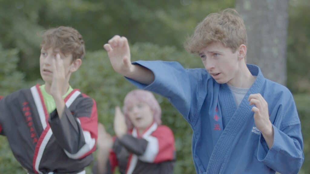 Students learning confidence in martial arts class.