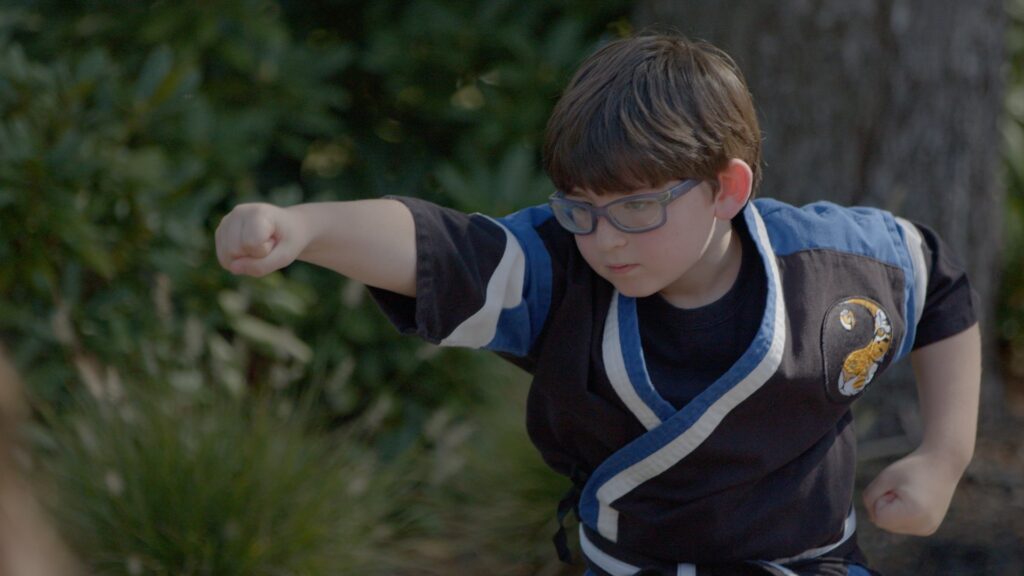 Student learning self defense in karate for kids class.