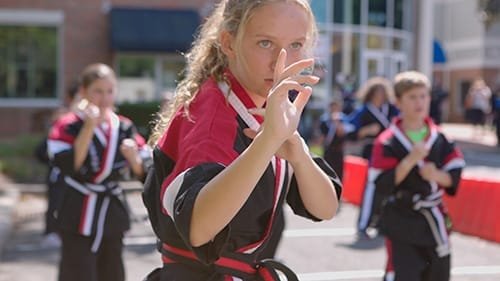 Kids practicing martial arts outdoors, focusing on self-defense and discipline in Fairfield.