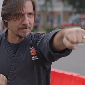 Martial arts instructor demonstrating technique outdoors, promoting self-defense and confidence in Fairfield.